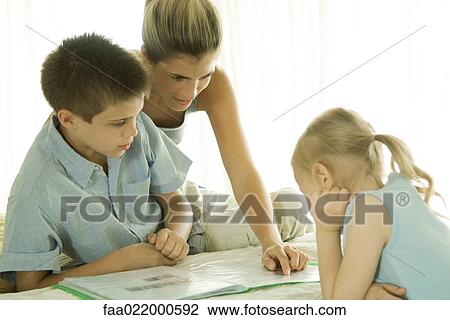 Mother helping children with homework View Large Photo Image Stock Image - Mother helping children with homework. Fotosearch