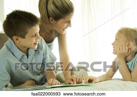 Mother helping children with homework View Large Photo Image Stock Image - Mother helping children with homework. Fotosearch