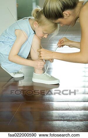 Mother helping little girl tie shoe laces View Large Photo Image Stock Image - Mother helping little girl tie shoe laces. Fotosearch