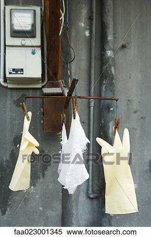 Stock Photography - Plastic gloves and rag hanging to dry. Fotosearch