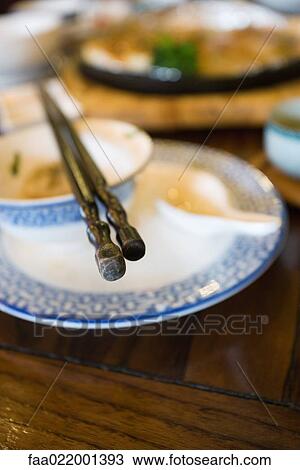 Stock Image - Plate with bowl, soup spoon and chopsticks. Fotosearch