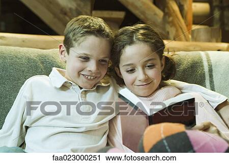 Preteen boy and girl reading book together View Large Photo Image Stock Image - Preteen boy and girl reading book together. Fotosearch