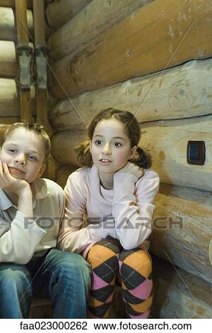 Preteen boy and girl sitting side by side, looking out of frame View Large Photo Image Stock Image - Preteen boy and girl sitting side by side, looking out of frame. Fotosearch