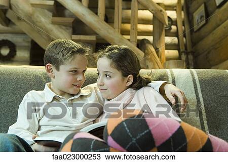 Preteen boy and girl with book, smiling at each other View Large Photo Image Stock Image - Preteen boy and girl with book, smiling at each other. Fotosearch