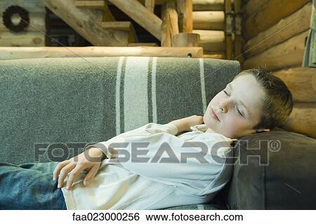 Preteen boy falling asleep on couch View Large Photo Image Stock Photograph - Preteen boy falling asleep on couch. Fotosearch