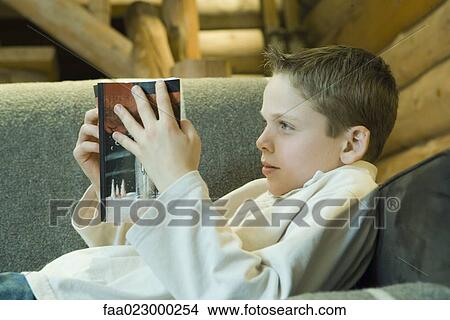 Preteen boy reading book View Large Photo Image Picture - Preteen boy reading book. Fotosearch
