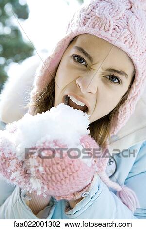 Preteen girl eating snow out of mittened hands, snarling and looking at camera View Large Photo Image Stock Image - Preteen girl eating snow out of mittened hands, snarling and looking at camera. Fotosearch