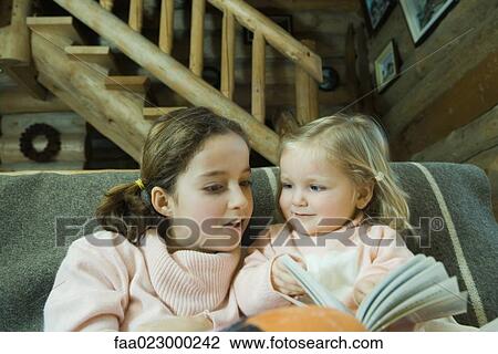 Preteen girl reading book with toddler View Large Photo Image Stock Image - Preteen girl reading book with toddler. Fotosearch