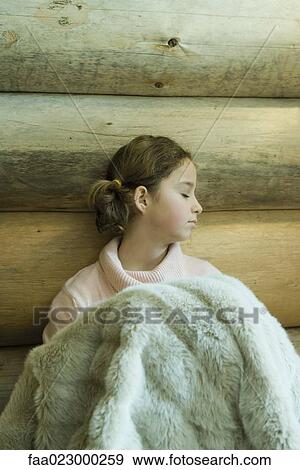 Preteen girl sitting under warm blanket, eyes closed View Large Photo Image Stock Photo - Preteen girl sitting under warm blanket, eyes closed. Fotosearch