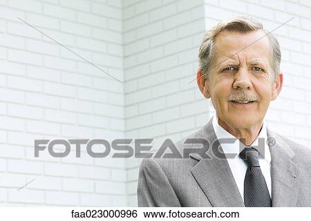 Senior businessman smiling at camera, portrait View Large Photo Image Stock Photograph - Senior businessman smiling at camera, portrait. Fotosearch