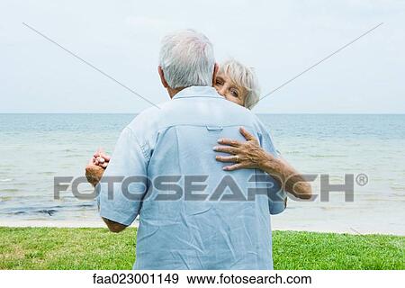Senior couple dancing on sidewalk overlooking ocean, waist up View Large Photo Image Stock Photo - Senior couple dancing on sidewalk overlooking ocean, waist up. Fotosearch