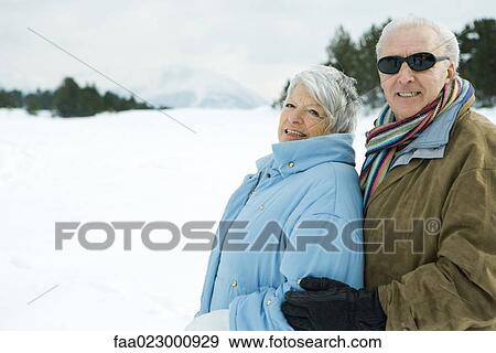 Stock Photo - Senior couple embracing, outdoors, smiling at camera, portrait. Fotosearch