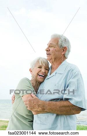 Senior couple hugging and laughing, waist up View Large Photo Image Picture - Senior couple hugging and laughing, waist up. Fotosearch