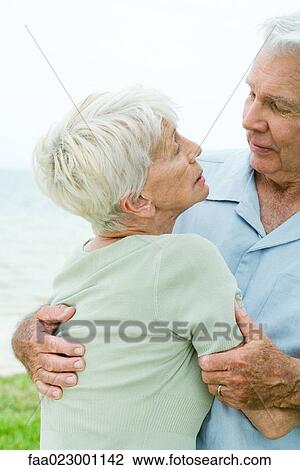 Senior couple talking, man holding woman in his arms View Large Photo Image Stock Image - Senior couple talking, man holding woman in his arms. Fotosearch