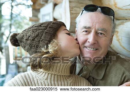 Senior man smiling at camera, granddaughter kissing him on the cheek, portrait View Large Photo Image Stock Photography - Senior man smiling at camera, granddaughter kissing him on the cheek, portrait. Fotosearch