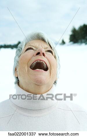 Senior woman laughing in snowy landscape, portrait View Large Photo Image Stock Photo - Senior woman laughing in snowy landscape, portrait. Fotosearch