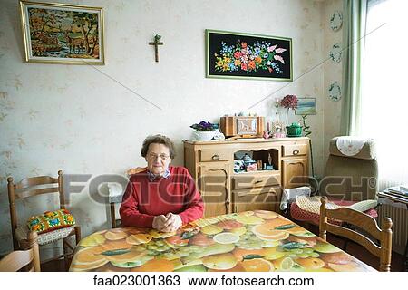 Senior woman sitting in home interior View Large Photo Image Stock Image - Senior woman sitting in home interior. Fotosearch