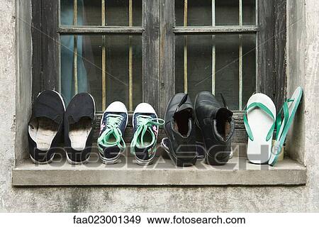 Shoes lined up on windowsill View Large Photo Image Stock Photo - Shoes lined up on windowsill. Fotosearch