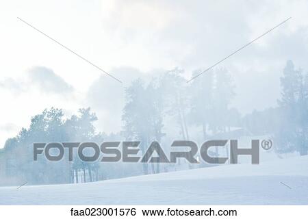 Snow-covered slope, snow blowing in air View Large Photo Image Stock Photograph - Snow-covered slope, snow blowing in air. Fotosearch