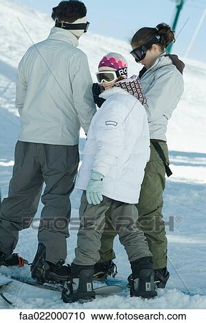 Snowboarders standing in snow, candid shot, full length View Large Photo Image Stock Image - Snowboarders standing in snow, candid shot, full length. Fotosearch