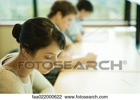 Stock Image - Students studying in university library. Fotosearch