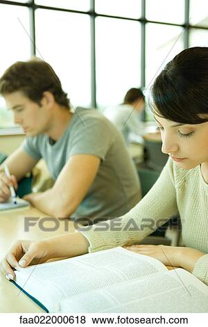 Stock Photo - Students studying in university library. Fotosearch