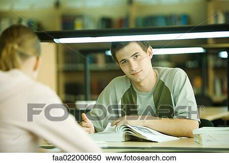 Students studying in university library, teen boy smiling at camera View Large Photo Image Stock Image - Students studying in university library, teen boy smiling at camera. Fotosearch