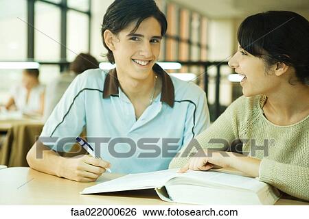 Students studying together in university library View Large Photo Image Stock Photograph - Students studying together in university library. Fotosearch