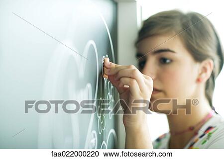 Teen girl drawing on chalkboard View Large Photo Image Stock Image - Teen girl drawing on chalkboard. Fotosearch