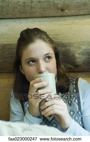 Teen girl drinking hot beverage View Large Photo Image Stock Photo - Teen girl drinking hot beverage. Fotosearch
