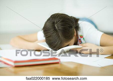 Teen girl lying on floor, doing homework, resting face in book View Large Photo Image Stock Photography - Teen girl lying on floor, doing homework, resting face in book. Fotosearch