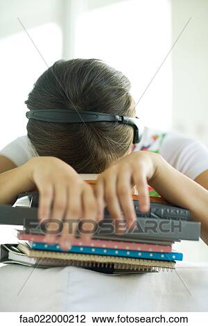 Teen girl resting head on stack of homework View Large Photo Image Stock Image - Teen girl resting head on stack of homework. Fotosearch