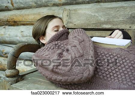 Teen girl sleeping with turtleneck pulled up over face and mouth, book on chest View Large Photo Image Stock Photo - Teen girl sleeping with turtleneck pulled up over face and mouth, book on chest. Fotosearch