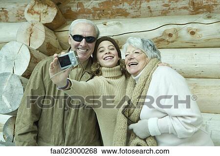 Teen girl taking photo of self with grandparents View Large Photo Image Stock Photo - Teen girl taking photo of self with grandparents. Fotosearch