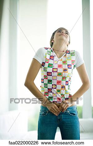 Teen girl trying to button jeans View Large Photo Image Stock Photograph - Teen girl trying to button jeans. Fotosearch