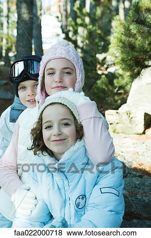 Teen girl with preteen boy and girl, wearing winter coats and hats, portrait View Large Photo Image Stock Photo - Teen girl with preteen boy and girl, wearing winter coats and hats, portrait. Fotosearch