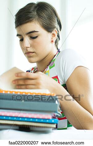 Stock Photo - Teen girl with stack of homework, portrait. Fotosearch