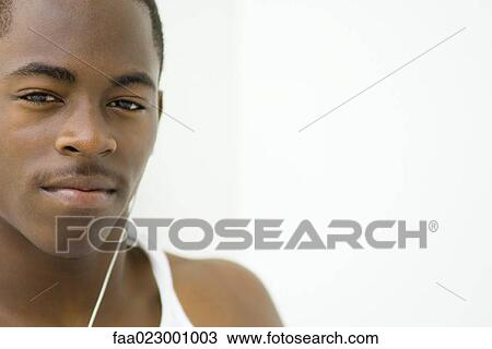 Stock Image - Teenage boy looking at camera, portrait. Fotosearch