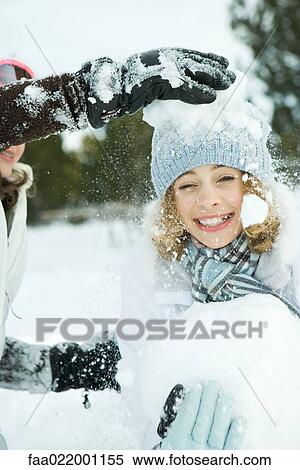Teenage girl being hit with snowballs, smiling at camera View Large Photo Image Stock Photography - Teenage girl being hit with snowballs, smiling at camera. Fotosearch