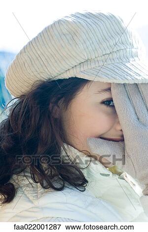 Teenage girl covering part of face with gloved hand, close-up View Large Photo Image Stock Photo - Teenage girl covering part of face with gloved hand, close-up. Fotosearch