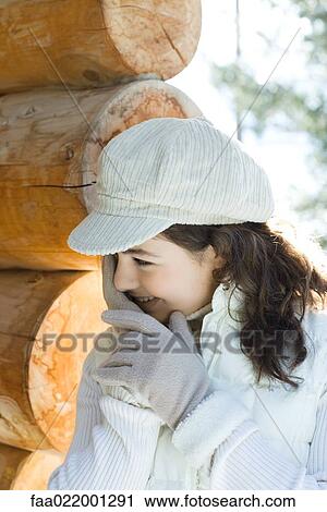 Stock Image - Teenage girl hiding face, portrait. Fotosearch