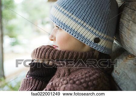 Teenage girl holding sweater neck over chin, side view, close-up View Large Photo Image Stock Photo - Teenage girl holding sweater neck over chin, side view, close-up. Fotosearch
