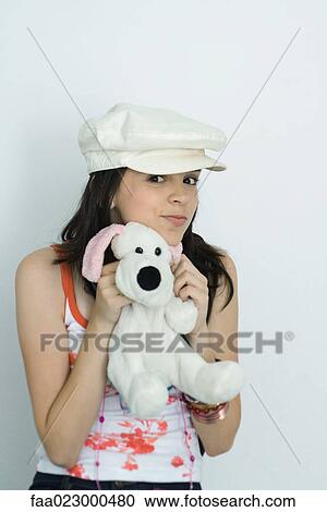 Teenage girl holding up stuffed toy, smiling at camera, portrait View Large Photo Image Stock Image - Teenage girl holding up stuffed toy, smiling at camera, portrait. Fotosearch