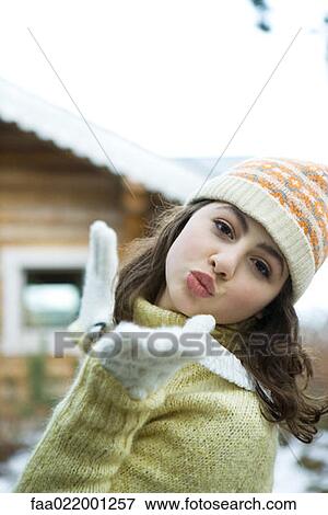 Teenage girl in winter clothes blowing kiss to camera View Large Photo Image Stock Photo - Teenage girl in winter clothes blowing kiss to camera. Fotosearch
