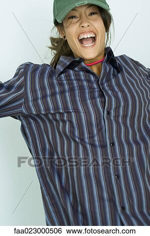 Teenage girl jumping, smiling at camera, portrait View Large Photo Image Stock Photograph - Teenage girl jumping, smiling at camera, portrait. Fotosearch