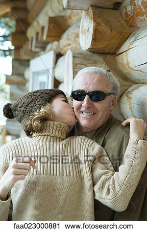 Teenage girl kissing grandfather on the cheek, portrait View Large Photo Image Stock Image - Teenage girl kissing grandfather on the cheek, portrait. Fotosearch