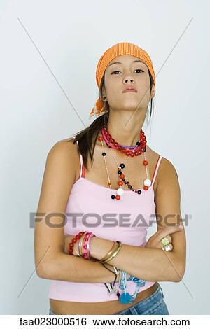 Teenage girl looking at camera, arms folded, head back, portrait View Large Photo Image Stock Photograph - Teenage girl looking at camera, arms folded, head back, portrait. Fotosearch