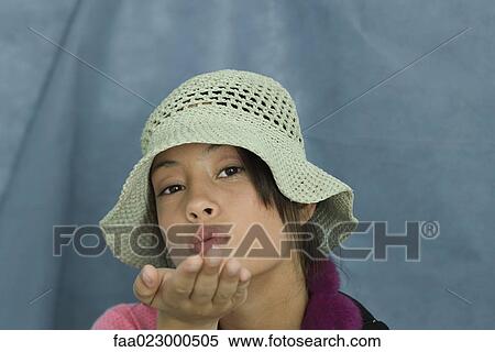 Teenage girl looking at camera, blowing a kiss, portrait View Large Photo Image Stock Photography - Teenage girl looking at camera, blowing a kiss, portrait. Fotosearch