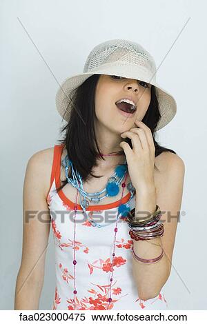 Teenage girl looking at camera, wearing hat, open mouth View Large Photo Image Stock Photography - Teenage girl looking at camera, wearing hat, open mouth. Fotosearch