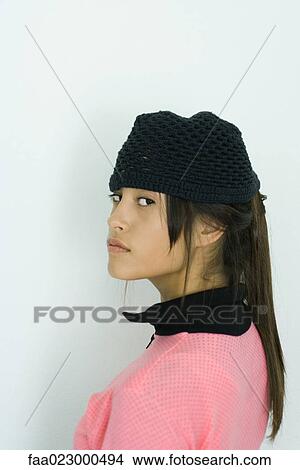 Teenage girl looking over shoulder at camera, portrait View Large Photo Image Picture - Teenage girl looking over shoulder at camera, portrait. Fotosearch